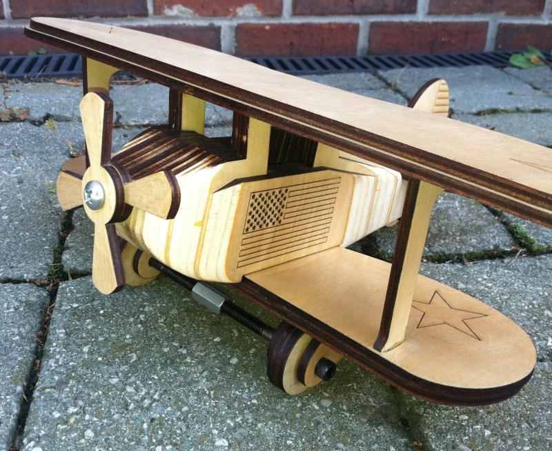 wooden biplane with the American Flag laser-engraved on it!